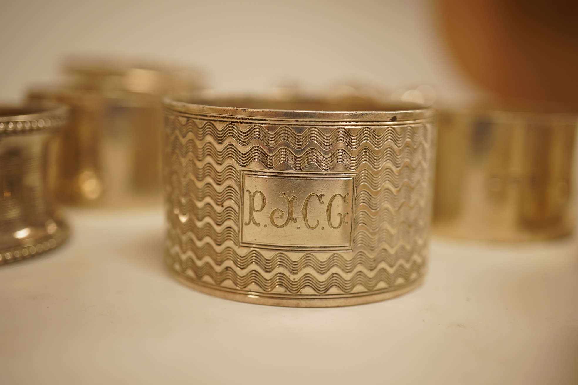 A pair of Edwardian pieced silver napkin rings by Henry Wigfull, Sheffield, 1905, together with nine other assorted silver napkin rings.